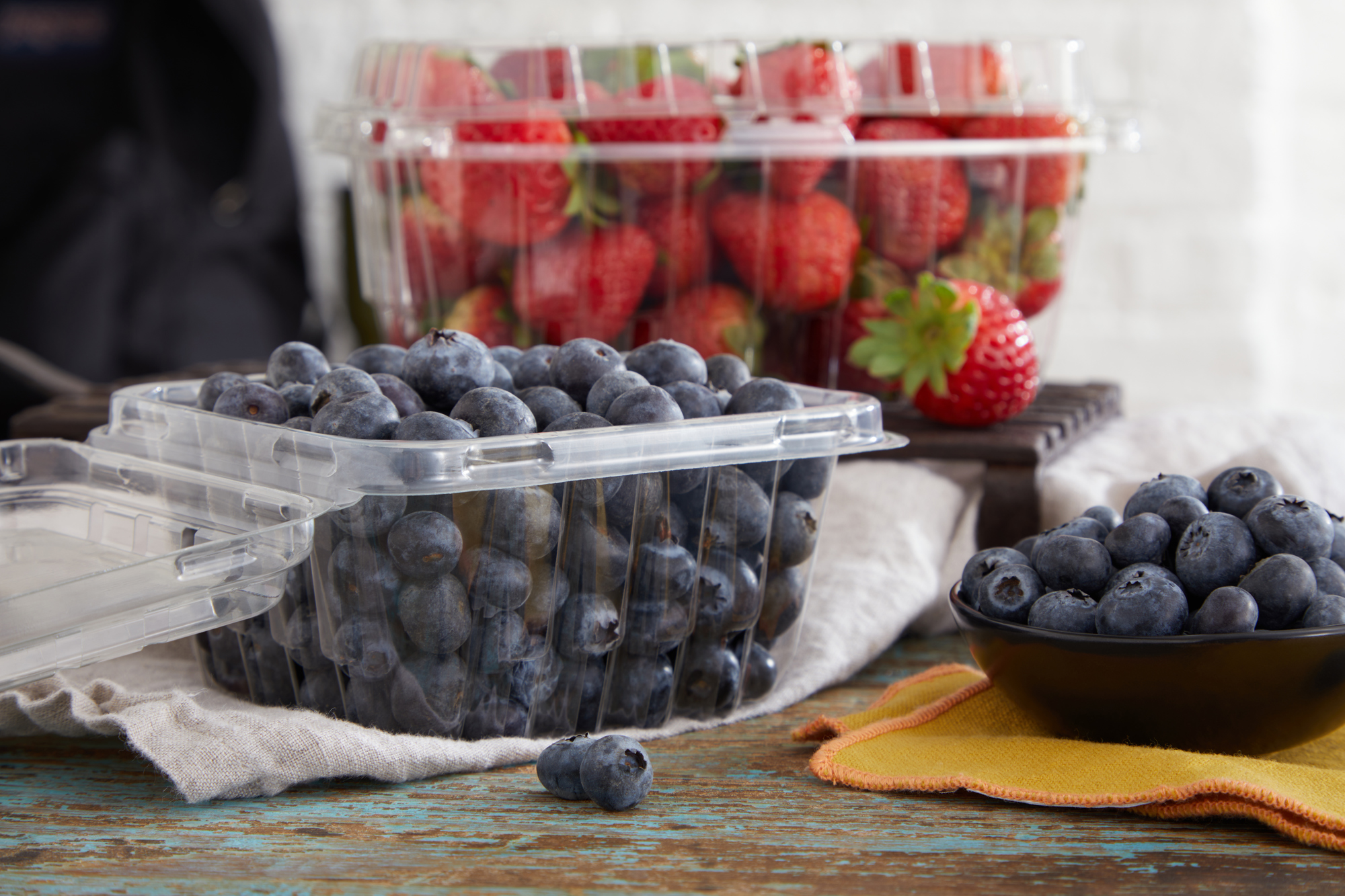 fresh strawberries and blueberries in clear containers